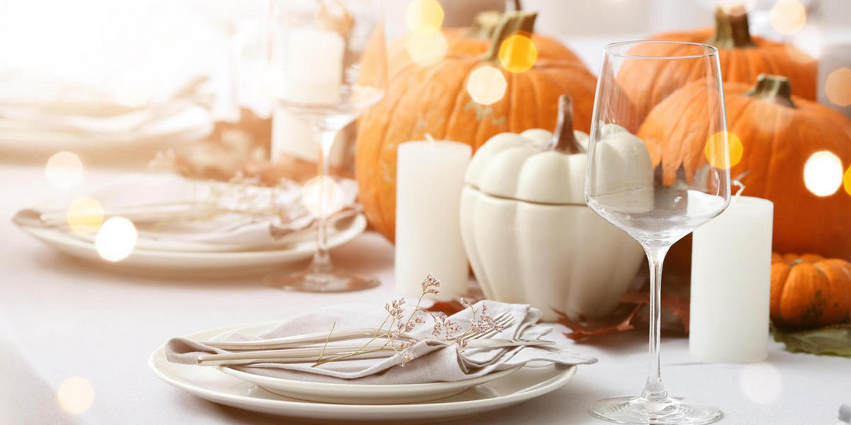 place settings with pumpkins and candles